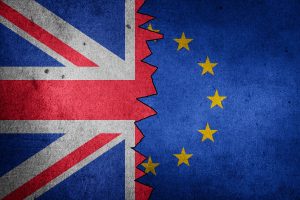 The british flag and the eu flag are torn apart.