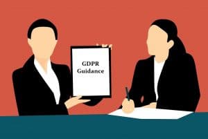 Two women holding up a sign that says gdpr guidance.