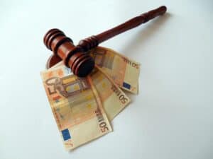 A gavel on top of a stack of euro banknotes.
